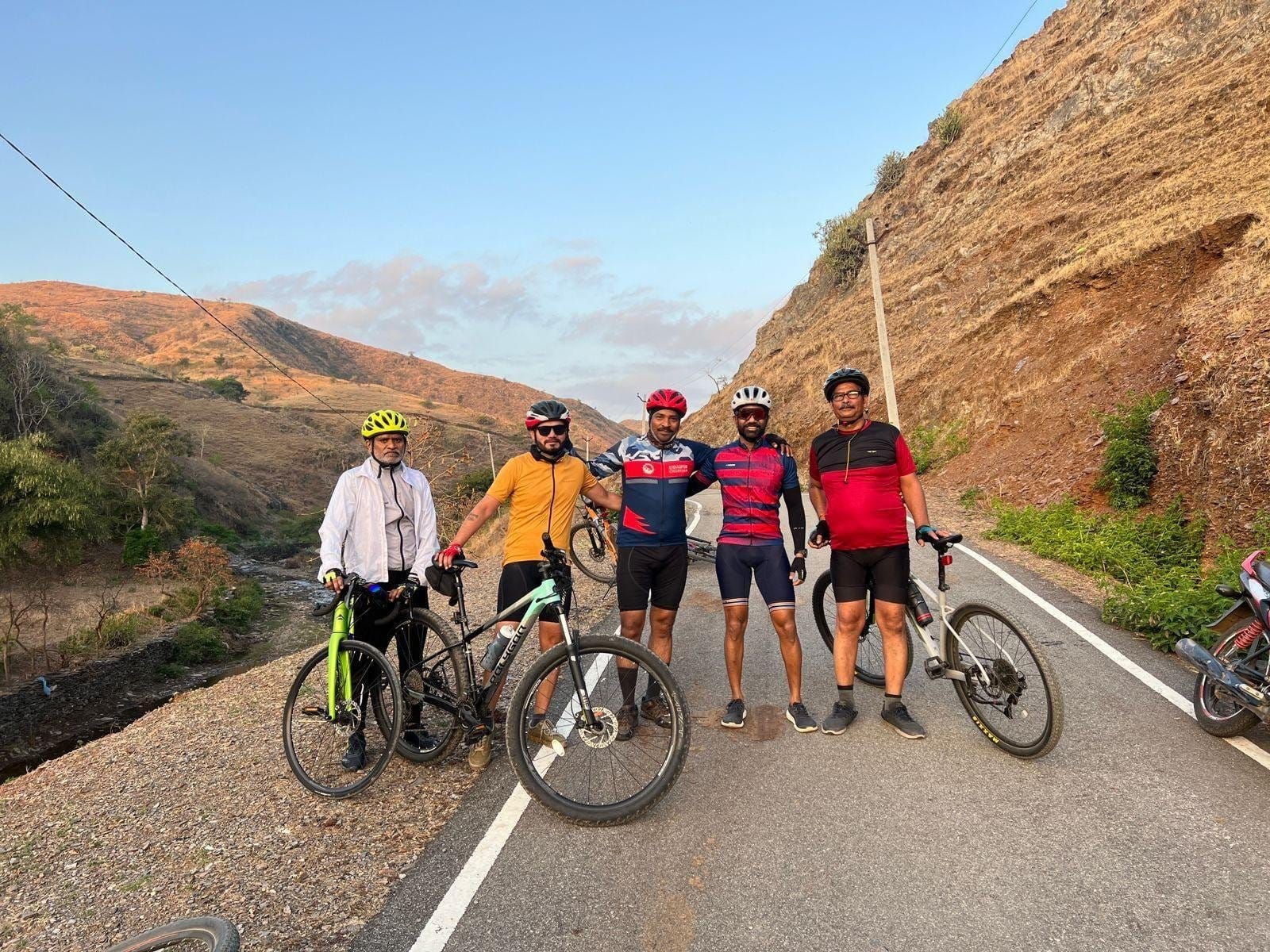 Riders on a hill road at sunrise
