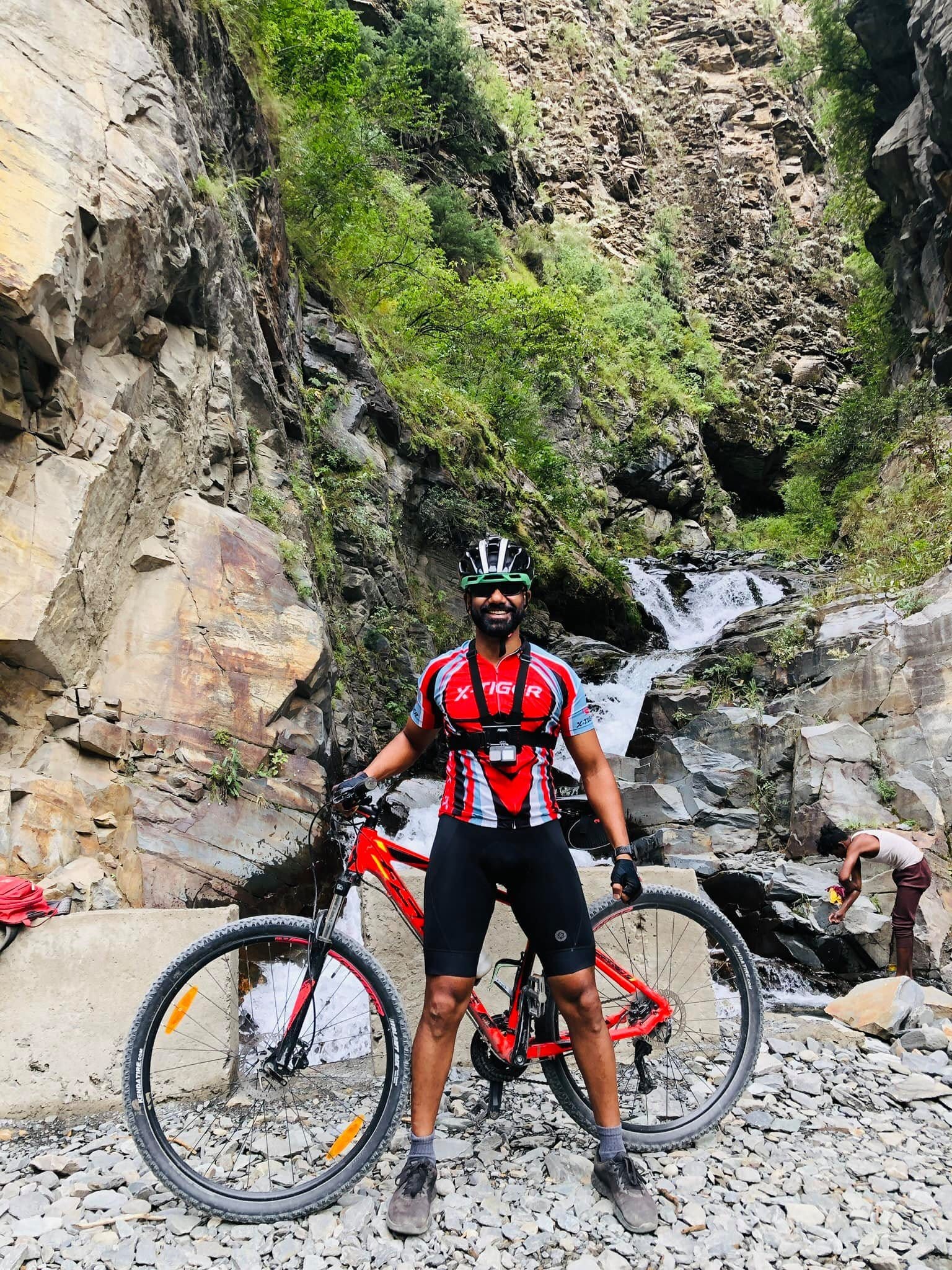 Rider beside a mountain waterfall
